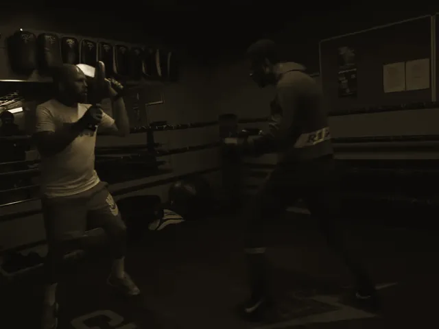 Tyson Isa hitting pads in the ring with his trainer.